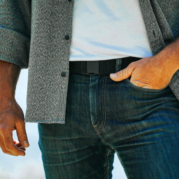 Jelt Venture Adjustable belt shown worn by a man with jeans, a white t-shirt and button down shirt.