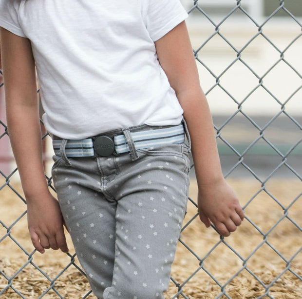 Girl wearing Jelt Junior stretch belt in Cool Blue Stripe