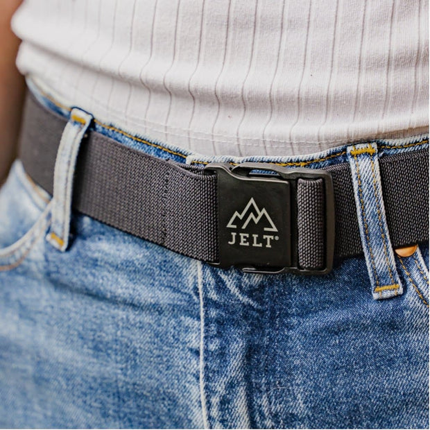 Close up photo of woman in jeans wearing a Jelt Venture belt in black.