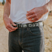 Man wearing Camo Jelt elastic belt with jeans and white t-shirt