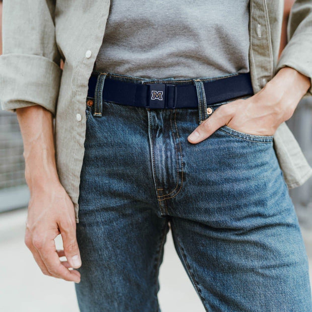 Montana State University "M" JeltX Adjustable belt in navy by Jelt belts. Shown on a man in jeans and button-down shirt.