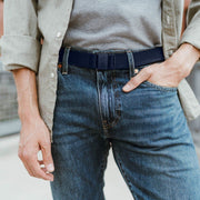 JeltX Adjustable belt in navy. Pictured on guy with jeans and button down shirt.